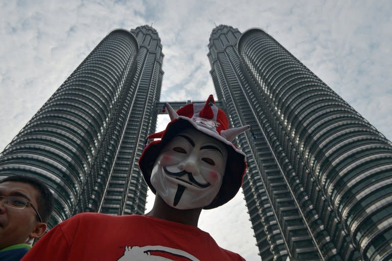 A protester takes part in a rally for electorial reforms in front of the Malaysia's iconic Petronas Twin Towers in Kuala Lumpur on January 12, 2013. Close to 100,000 people tool part in the rally, paralysing much of the capital Kuala Lumpur in one of Malaysia's biggest-ever political gatherings