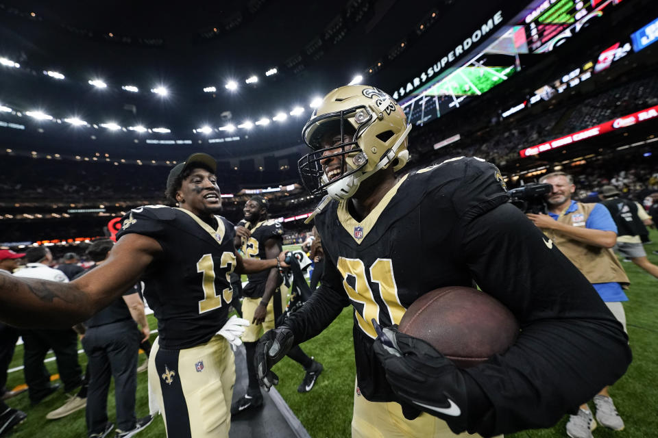 New Orleans Saints wide receiver Michael Thomas (13) celebrates with defensive end Kyle Phillips (91) after Phillips made an interception in the second half of a preseason NFL football game against the Kansas City Chiefs in New Orleans, Sunday, Aug. 13, 2023. (AP Photo/Gerald Herbert)