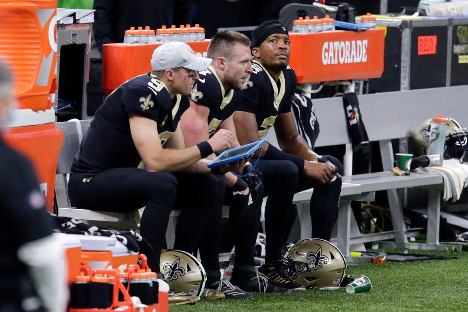 Drew Brees (left) sits with Taysom Hill and Jameis Winston during the game against the 49ers on Nov. 15, 2020.