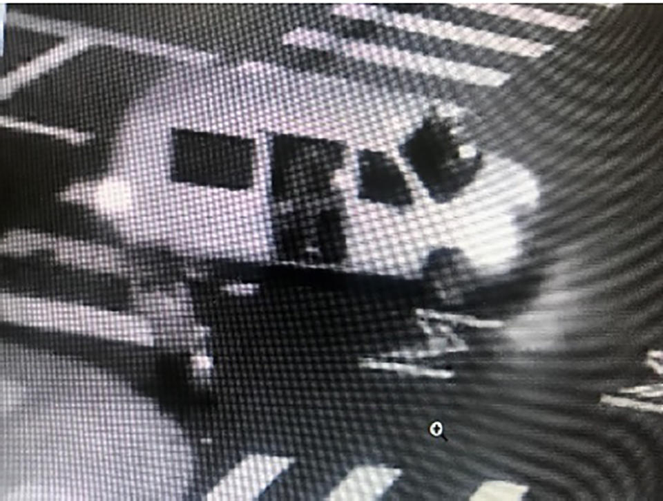 This May 29, 2020, surveillance photo provided by the FBI shows a van with the passenger side door open as someone fires at a security kiosk at the Ronald V. Dellums Federal Building in Oakland, Calif. Robert Alvin Justus Jr. is accused of being the driver of the van from which U.S. Air Force Staff Sgt. Steven Carrillo allegedly shot and killed federal officer Dave Patrick Underwood, 53, and wounded of another officer in the incident. (FBI via AP)