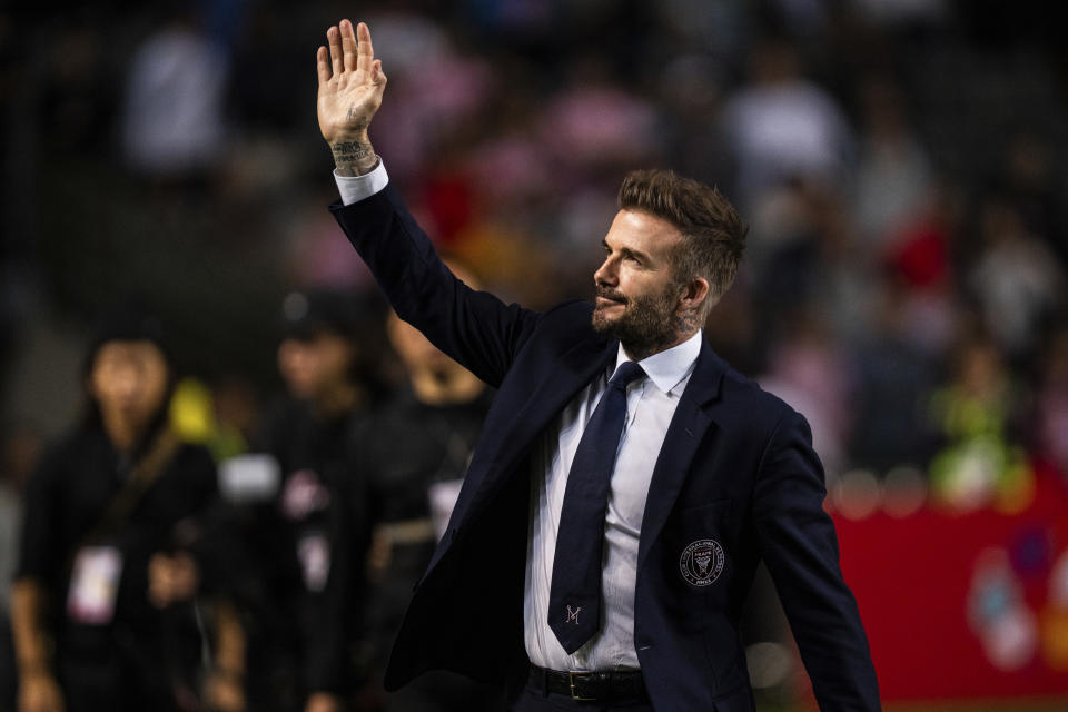 Inter Miami's co-owner David Beckham waves to the crowd after the friendly football match between Hong Kong Team and US Inter Miami CF at the Hong Kong Stadium in Hong Kong, Sunday, Feb. 4, 2024. (AP Photo/Louise Delmotte)