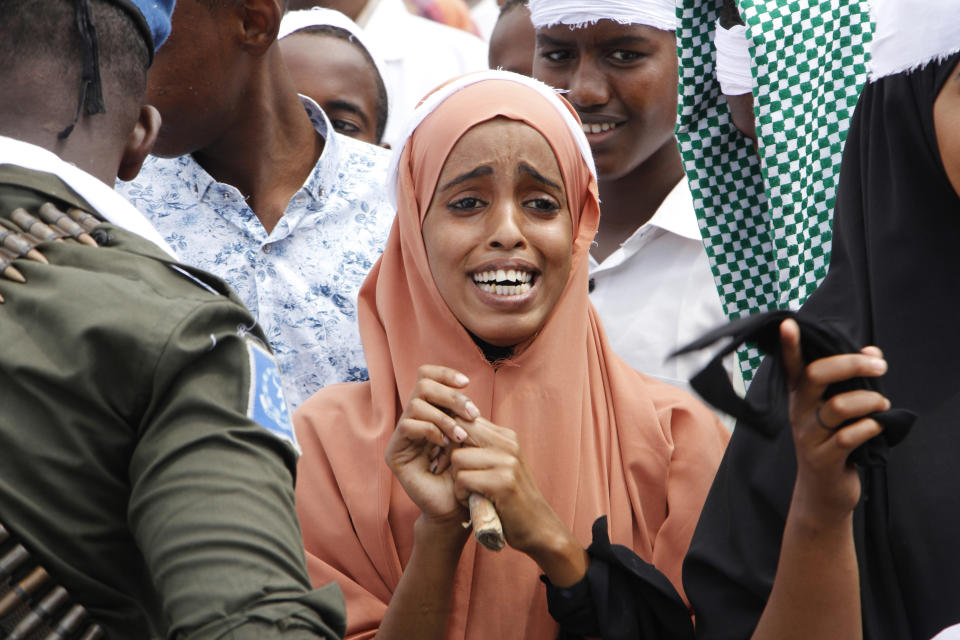 A woman weeps at Zobe junction during the anniversary an explosion in the capital of Mogadishu, Somalia, Sunday Oct. 14, 2018. Somalia is marking the first anniversary of one of the world's deadliest attacks since 9/11, a truck bombing in the heart of Mogadishu that killed well over 500 people. The Oct. 14, 2017 attack was so devastating that the al-Shabab extremist group that often targets the capital never claimed responsibility amid the local outrage. (AP Photo/Farah Abdi Warsameh)