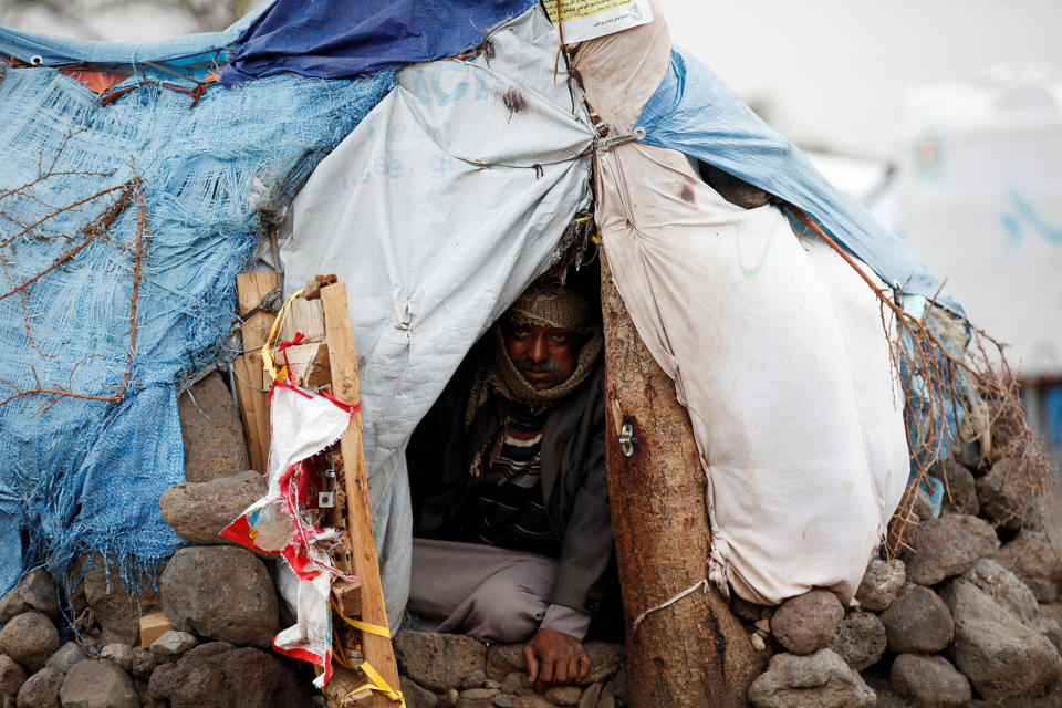 Man sits in his hut at a camp for internally displaced people