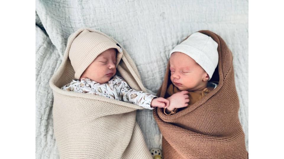 Newborn babies sleeping beside each other