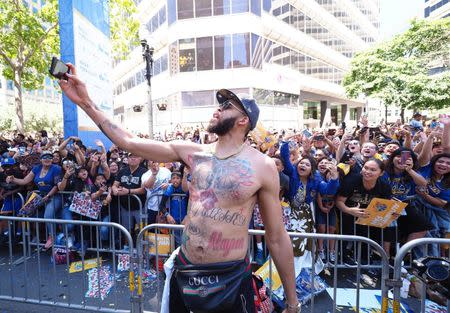 Jun 12, 2018; Oakland, CA, USA; Golden State Warriors center JaVale McGee (1) takes a selfie with fans during the championship parade in downtown Oakland. Mandatory Credit: Kelley L Cox-USA TODAY Sports