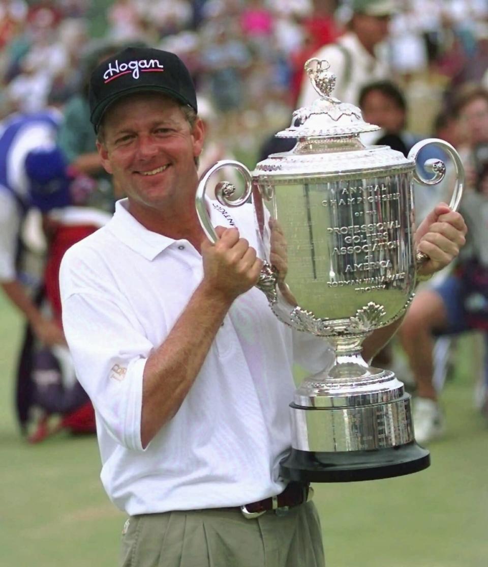 FILE - Mark Brooks holds the Wannamaker trophy on the 18th green of Valhalla Golf Club after beating Kenny Perry in a one-hole playoff to win the PGA Championship on Sunday afternoon, Aug. 11, 1996, in Louisville, Ky. Valhalla hosts its fourth major championship on May 16-19, 2024. (AP Photo/Ed Reinke, File)