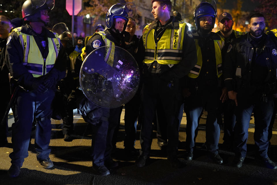 U.S. Capitol Police officers stand outside the headquarters of the Democratic National Committee Wednesday, Nov. 15, 2023, in Washington. (AP Photo/Nathan Howard)