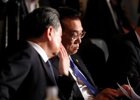 Chinese Premier Li Keqiang and Chinese State Councilor and Foreign Minister Wang Yi attend at their trilateral summit with Japan's Prime Minister Shinzo Abe and South Korea's President Moon Jae-in (not in picture) at Akasaka Palace state guest house in Tokyo, Japan May 9, 2018. REUTERS/Kim Kyung-Hoon/Pool