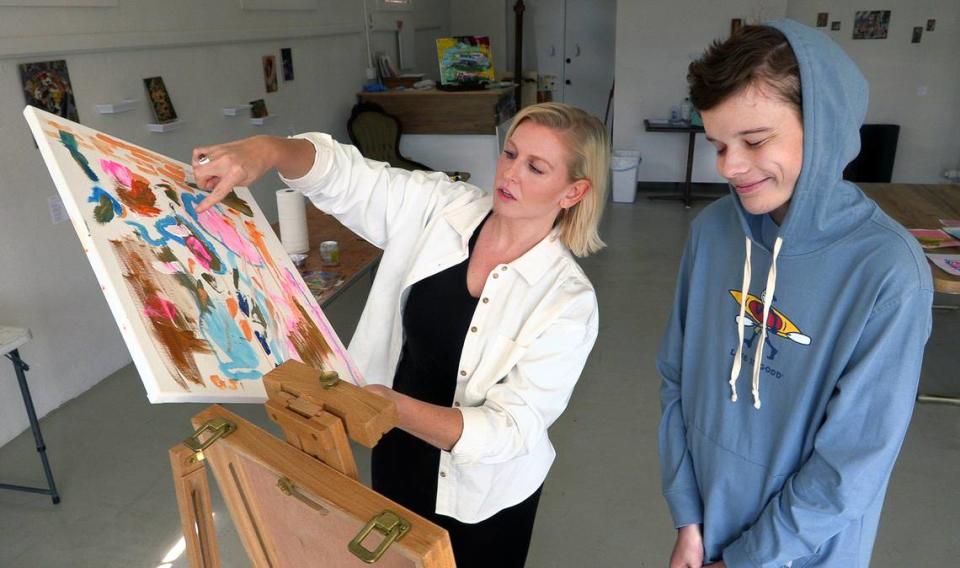 Cora King, left, works with George Jenkins during a recent art lesson. An exhibition of George’s art, “The World Through George’s Eyes,” opens in the King Gallery, 3211 Howard Ave., with a reception on April 13 from 6-8 p.m. All proceeds from sales during the show will go to Easterseals West Georgia, where George has received therapeutic care since he was 2.