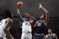 Connecticut's Adama Sanogo goes up for a basket as Georgetown's Ryan Mutombo (21) defends in the first half of an NCAA college basketball game, Tuesday, Jan. 25, 2022, in Storrs, Conn. (AP Photo/Jessica Hill)