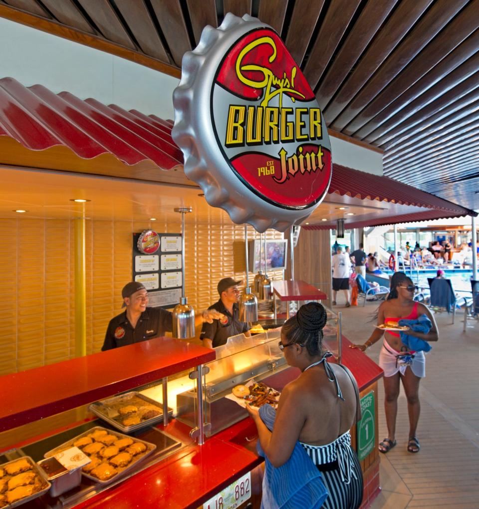 Guests aboard the Carnival Sunrise are served burgers cooked to order at Guy's Burger Joint. The eatery is inspired by Food Network star Guy Fieri. Photo by Andy Newman/Carnival Cruise Line