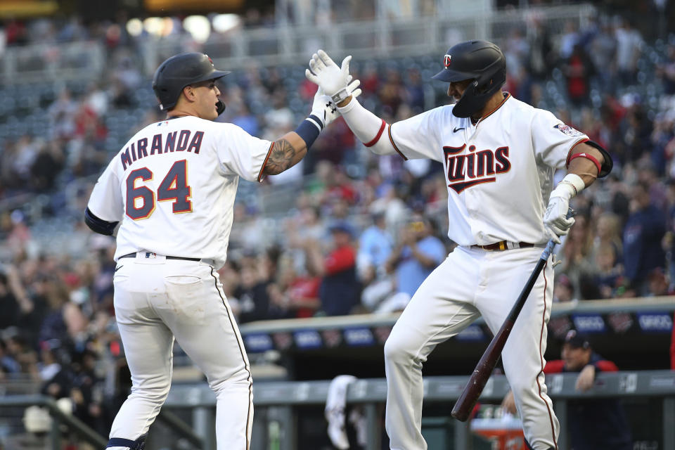 Minnesota Twins' Jose Miranda (64) high-fives Royce Lewis (23) after Miranda hit a home run during the second inning of the team's baseball game against the Oakland Athletics, Friday, May 6, 2022, in Minneapolis. (AP Photo/Stacy Bengs)