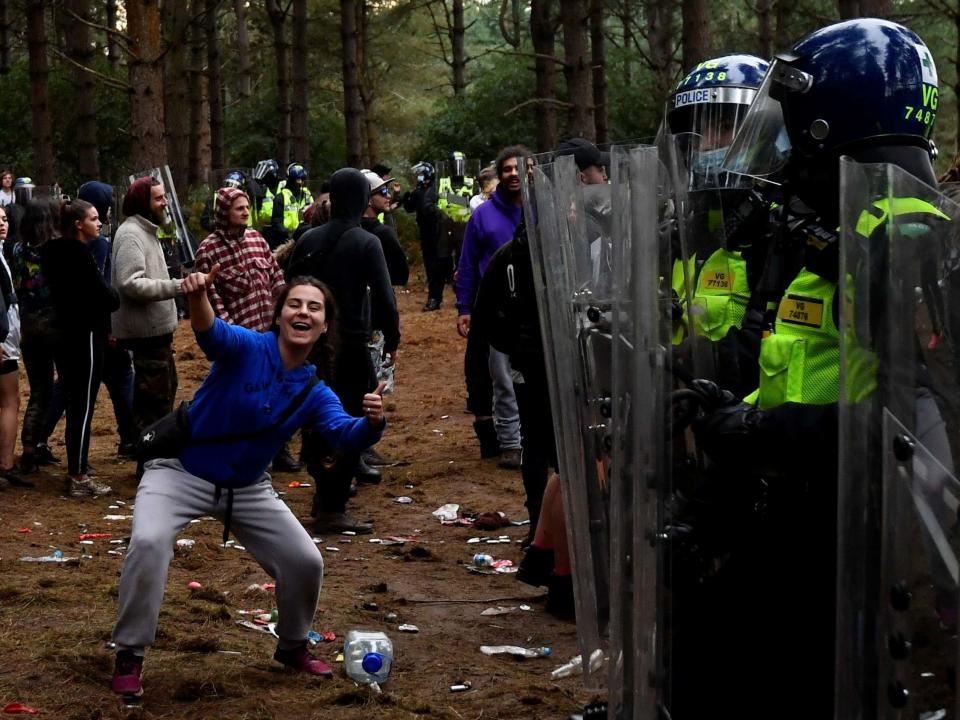 A reveller parties on at the scene of a suspected illegal rave in Norfolk on Sunday: REUTERS