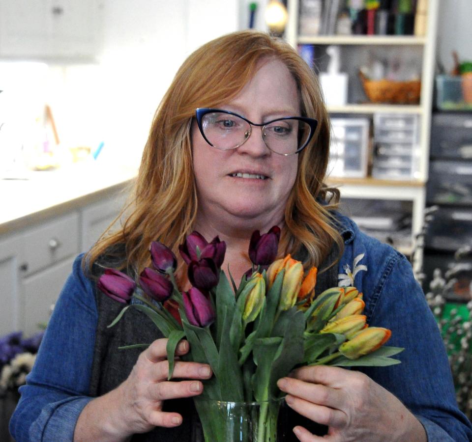 Enjoy Floral & Gift Boutique floral designer Carol Jump fills a vase with tulips for sale. The business also sells cheeses, giftboxes, cupcakes, cookies and dog treats. "We like to get unusual and fun things," she says.