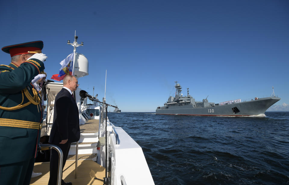 Russian President Vladimir Putin, second left, and Defence Minister Sergei Shoigu, left, arrive to attend the military parade during the Navy Day celebration in St.Petersburg, Russia, Sunday, July 26, 2020. (Alexei Druzhinin, Sputnik, Kremlin Pool Photo via AP)