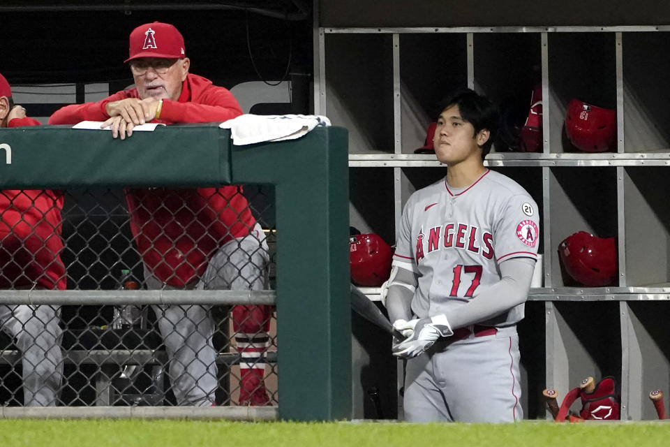 Los Angeles Angels manager Joe Maddon, left, and designated hitter Shohei Ohtani watch from the dugout during the fourth inning of the team's baseball game against the Chicago White Sox on Wednesday, Sept. 15, 2021, in Chicago. (AP Photo/Charles Rex Arbogast)