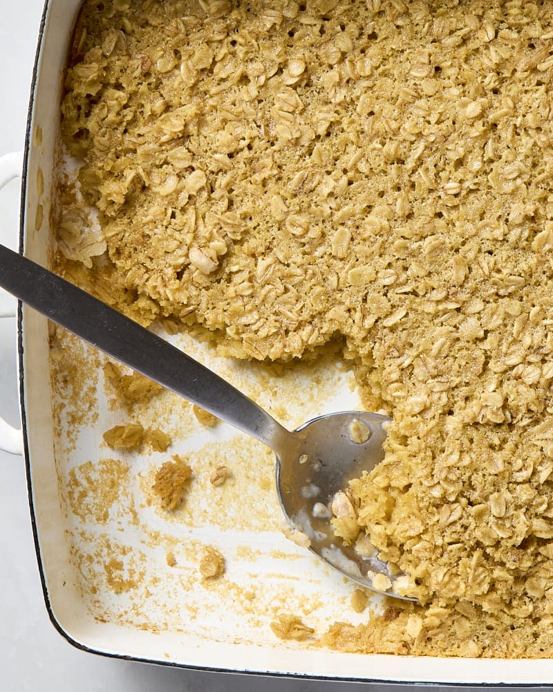 overhead shot of baked oatmeal in a baking dish with some taken from the bottom left corner of the baking dish