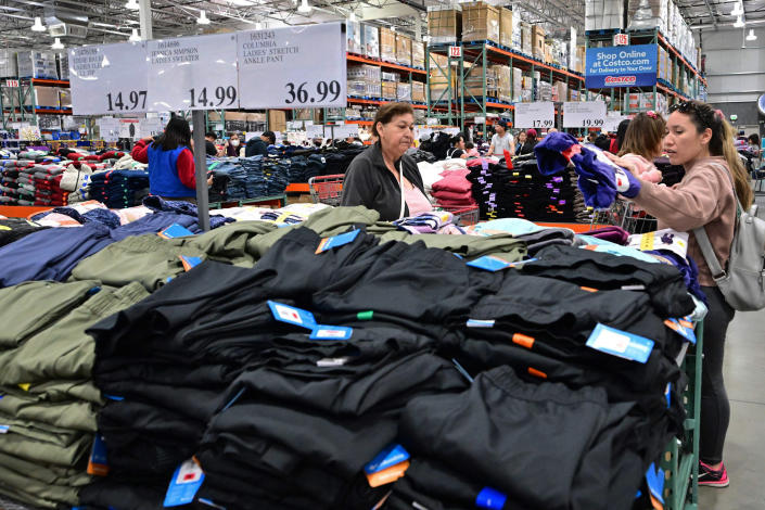 People shop for clothing at a Costco store (Frederic J. Brown / AFP via Getty Images file)
