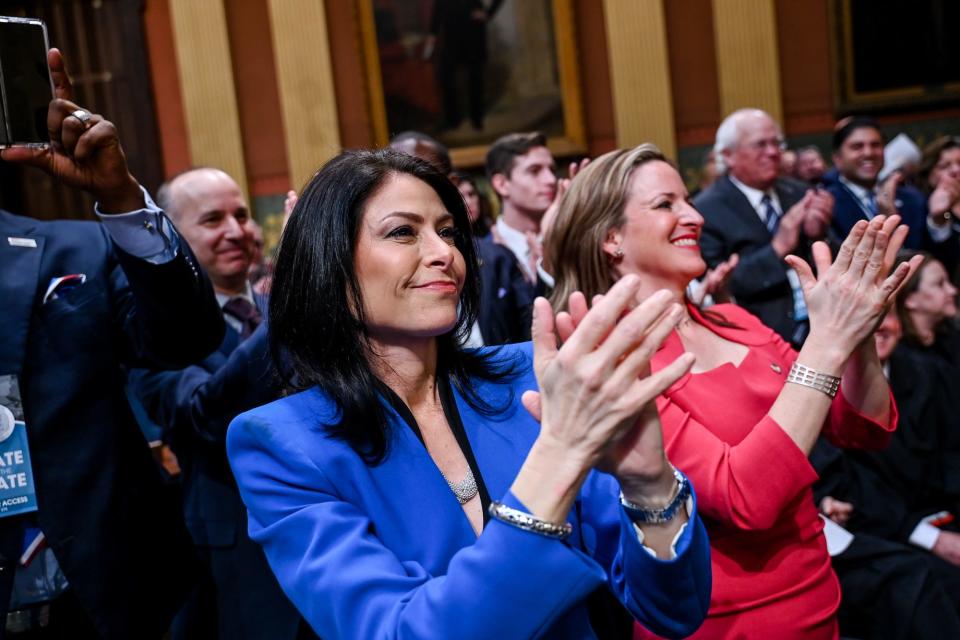 Michigan Attorney General Dana Nessel, left, and Secretary of State Jocelyn Benson clap during Gov. Gretchen Whitmer's State of the State address on Wednesday, Jan. 25, 2023, at the Michigan State Capitol in Lansing. 