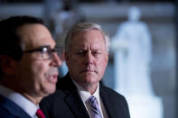 Treasury Secretary Steven Mnuchin, left, accompanied by White House Chief of Staff Mark Meadows, right, speak to reporters following a meeting with House Speaker Nancy Pelosi of Calif. and Senate Minority Leader Sen. Chuck Schumer of N.Y. as they continue to negotiate a coronavirus relief package on Capitol Hill in Washington, Friday, Aug. 7, 2020. (AP Photo/Andrew Harnik)