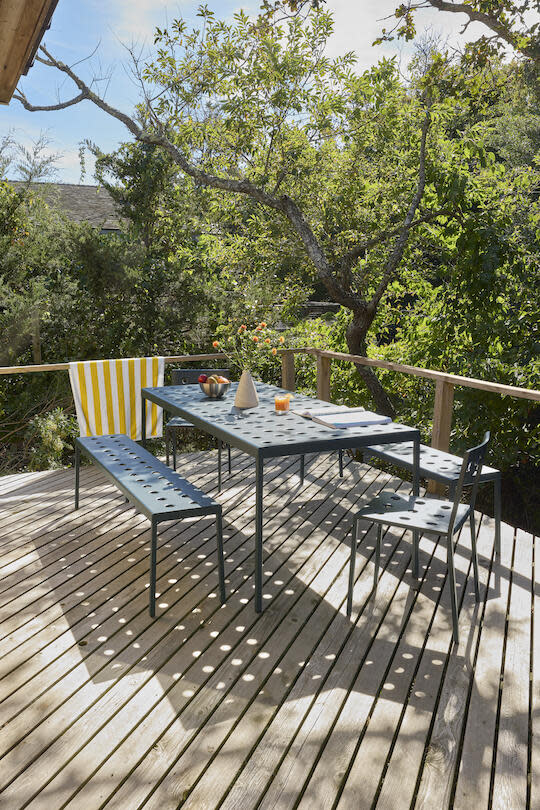 The Balcony collection from Hay makes for a breezy dining spot on the sun-dappled patio of BOND’s renovated Fire Island bungalow