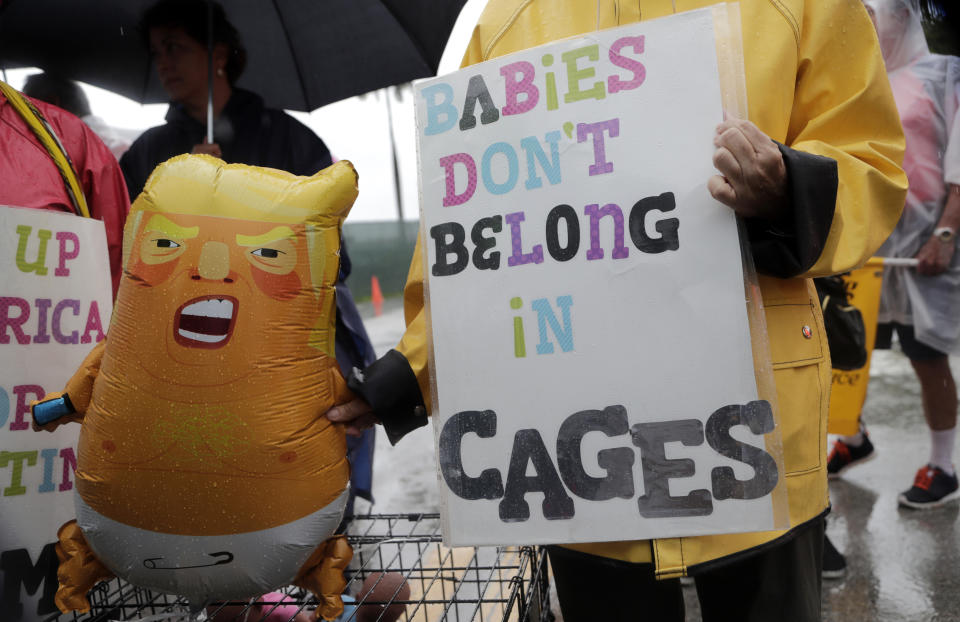 Protesters hold an inflatable doll in the likeness of President Donald Trump outside of the Homestead Temporary Shelter for Unaccompanied Children, Sunday, June 16, 2019, in Homestead, Fla. A coalition of religious groups and immigrant advocates said they want the Homestead detention center closed. (AP Photo/Lynne Sladky)