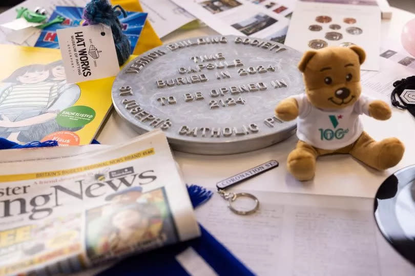 Some of the items in the time capsule include a miniature hat from the Hat Works Museum, today's MEN paper, a Manchester Worker Bee badge, Blossoms vinyl and mini Vernon Bear