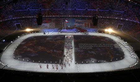 A map of Russia is projected onto the stadium floor as athletes march in during the opening ceremony of the 2014 Sochi Winter Olympics, February 7, 2014. REUTERS/Pawel Kopczynski