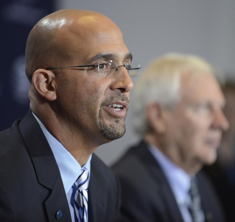 James Franklin, foreground, is introduced as Penn State's new football coach during a news conference on Saturday Jan. 11, 2014, in State College, Pa. Penn State president Rodney Erickson, background, looks on. (AP Photo/ John Beale)