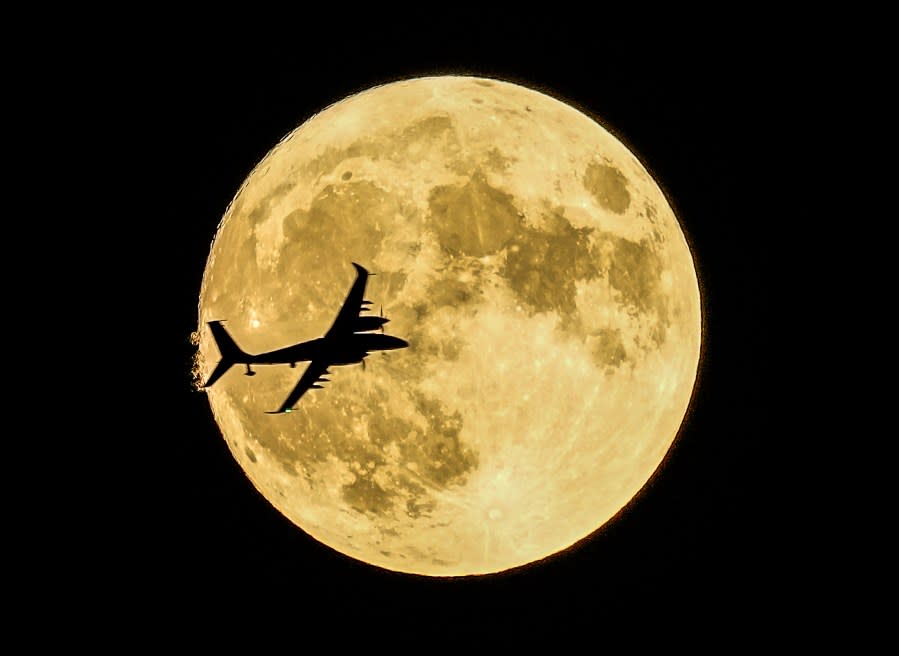 Akıncı unmanned aerial craft passing in front of the Supermoon during a demonstration flight on the first day of Teknofest technology and aerospace festival in Ankara, Turkey, Wednesday, Aug. 30, 2023. (AP Photo/Emrah Gurel)