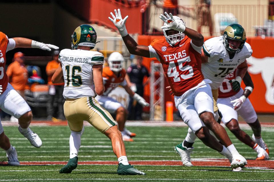 Texas defensive tackle Vernon Broughton, right, pressures Colorado State quarterback Brayden Fowler-Nicolosi during the Longhorns' 52-0 win at Royal-Memorial Stadium on Saturday. Texas coach Steve Sarkisian says his defensive tackle rotation will play a key role against Michigan this week.