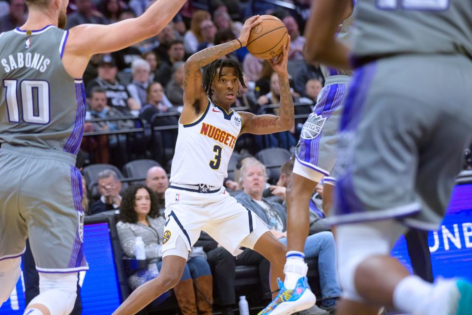 Denver Nuggets guard Bones Hyland (3) works the ball ball past Sacramento Kings defenders during the first quarter of an NBA basketball game in Sacramento, Calif., Wednesday, Dec. 28, 2022. (AP Photo/Randall Benton)