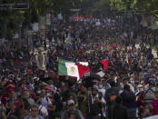 Relatives and classmates of the missing 43 Ayotzinapa college students and supporters march in Mexico City, Monday, Sept. 26, 2022, on the day of the anniversary of the disappearance of the students in Iguala, Guerrero state. Three members of the military and a former federal attorney general were recently arrested in the case, and few now believe the government's initial claim that a local drug gang and allied local officials were wholly to blame for seizing and killing the students on July 26, 2014, most of which have never been found. (AP Photo/Marco Ugarte)