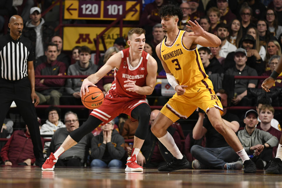 Wisconsin forward Tyler Wahl, left, tries to drive past Minnesota forward Dawson Garcia during the first half of an NCAA college basketball game on Sunday March 5, 2023, in Minneapolis. (AP Photo/Craig Lassig)