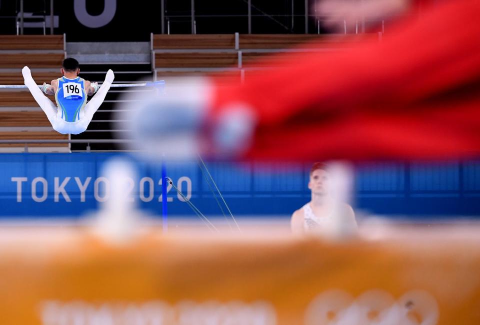 Azerbaijan's Rasuljon Abdurakhimov competes on the high bar.