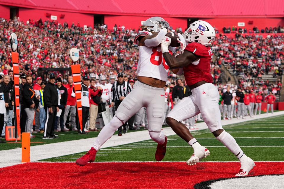 Nov 4, 2023; Piscataway, New Jersey, USA; Ohio State Buckeyes tight end Gee Scott Jr. (88) catches a touchdown while being defended by Rutgers Scarlet Knights linebacker Mohamed Toure (1) during the first half of the NCAA football game at SHI Stadium.