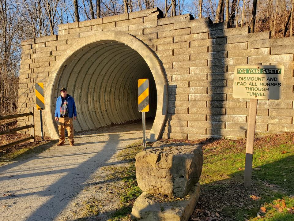 Joe Rinehart stands at a Wheeling & Lake Erie Railroad overpass on the Ohio & Erie Towpath Trail. In addition to being a great campground host, Joe is running for the Ohio House of Representatives 51st District seat. (IRV OSLIN FOR ASHLAND TIMES-GAZETTE)