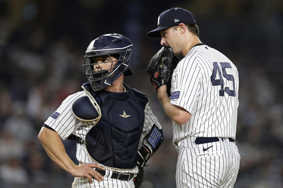 New York Yankees pitcher Gerrit Cole (45) talks with catcher Ben Rortvedt during the fourth inning of a baseball game against the Detroit Tigers, Tuesday, Sept. 5, 2023, in New York. (AP Photo/Adam Hunger)