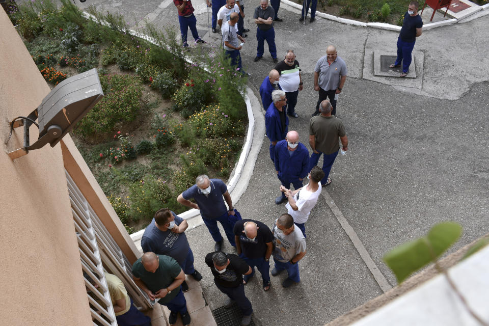 In this image released by Bosnia's Prison Administration inmates wait to get a COVID-19 vaccine at a prison in Zenica, Bosnia, Wednesday, Aug. 18, 2021. While Bosnia remains a laggard of Europe in coronavirus vaccinations, the people serving prison time in the Balkan country's correctional facilities have somewhat surprisingly emerged as its vaccine champions with over 80 percent of inmates in Bosnia's 13 prisons having received at least one Covid-19 vaccine dose.(Bosnian Prison Administration via AP)