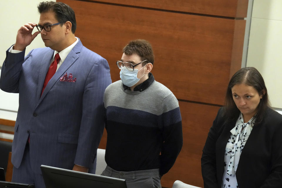 Marjory Stoneman Douglas High School shooter Nikolas Cruz stands with Chief Assistant Public Defender David Wheeler and sentence mitigation specialist Kate O'Shea, during the penalty phase of Cruz's trial at the Broward County Courthouse in Fort Lauderdale on Wednesday, July 27, 2022. Cruz previously plead guilty to all 17 counts of premeditated murder and 17 counts of attempted murder in the 2018 shootings. (Mike Stocker/South Florida Sun Sentinel via AP, Pool)