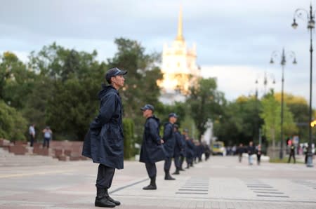 Law enforcement officers line up during a rally held by opposition supporters in Almaty