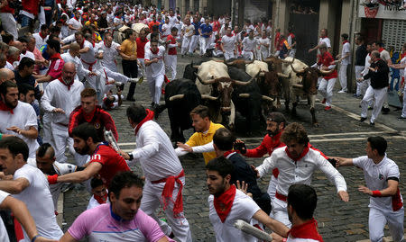 Runners sprint ahead of Fuente Ymbro fighting bulls during the fourth running of the bulls at the San Fermin festival in Pamplona, Spain July 10, 2017. REUTERS/Vincent West