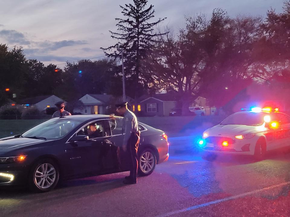 Students in the Columbus Police Public Safety Corps conduct a mock traffic stop on Wednesday outside the Columbus Police Academy on Hague Avenue.