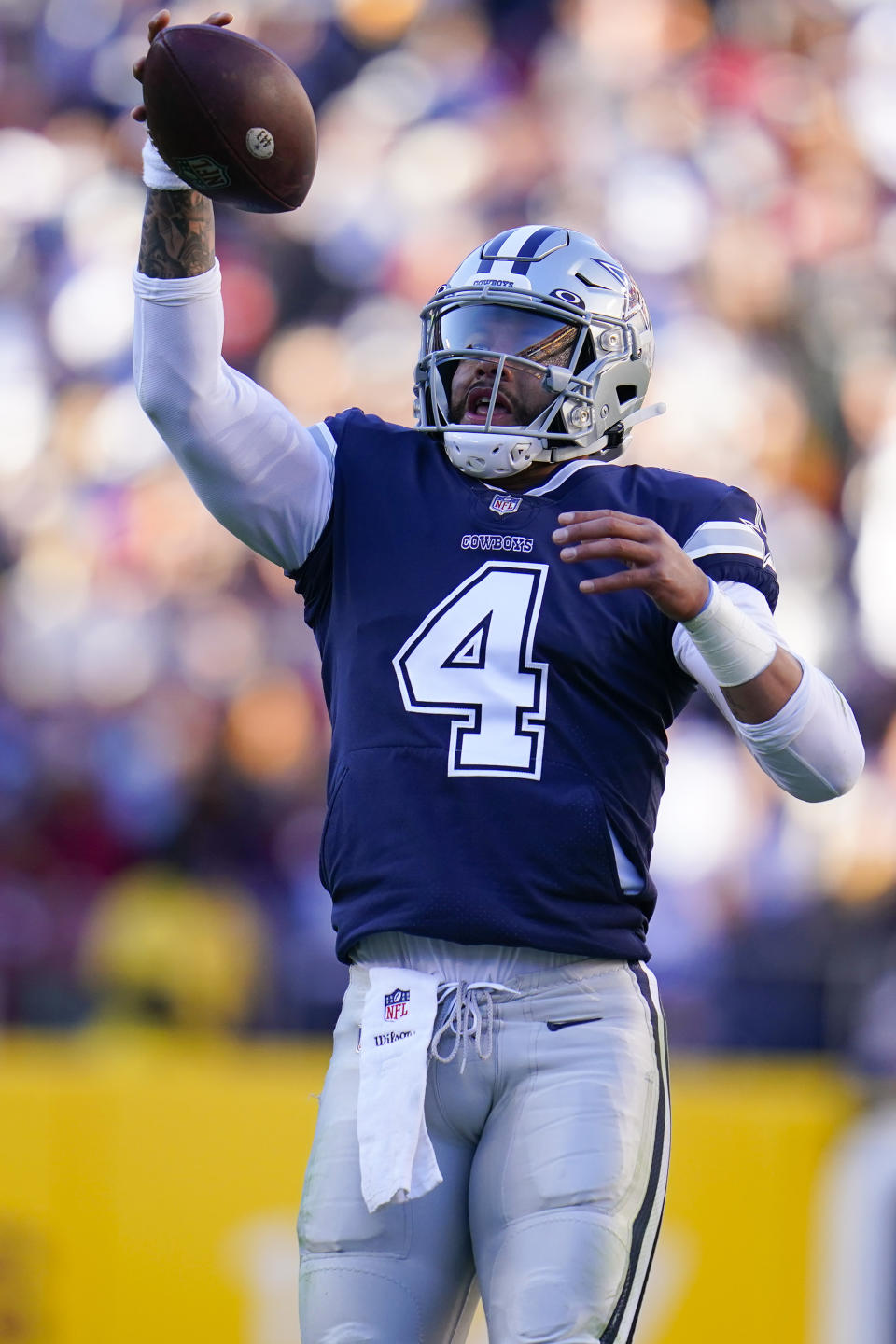 Dallas Cowboys quarterback Dak Prescott (4) catches a high snap during the first half of an NFL football game against the Washington Football Team, Sunday, Dec. 12, 2021, in Landover, Md. (AP Photo/Julio Cortez)