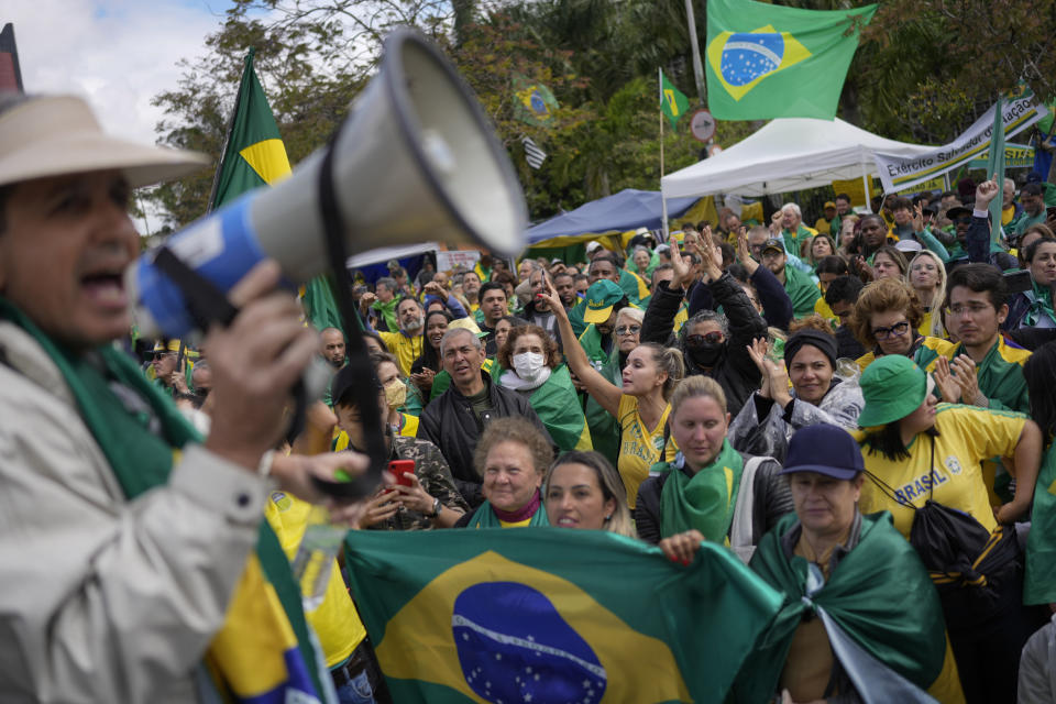 Supporters of outgoing President Jair Bolsonaro protest against his defeat in the country's presidential runoff, outside a military base in Sao Paulo, Brazil, Thursday, Nov. 3, 2022. Some supporters are calling on the military to keep Bolsonaro in power, even as his administration signaled a willingness to hand over the reins to his rival, President-elect Luiz Inacio Lula da Silva. (AP Photo/Matias Delacroix)