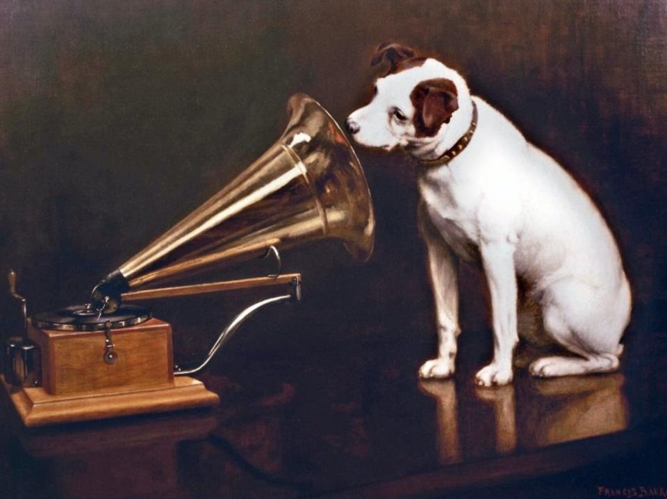 English artist Francis Barraud (1856-1924) painted his brother’s dog Nipper listening to the horn of an early phonograph in 1898. Victor Talking Machine Co. began using the symbol in its trademark, His Master’s Voice, in 1900. <a href="https://en.wikipedia.org/wiki/His_Master%27s_Voice#/media/File:His_Master's_Voice.jpg" rel="nofollow noopener" target="_blank" data-ylk="slk:Wikipedia;elm:context_link;itc:0;sec:content-canvas" class="link ">Wikipedia</a>