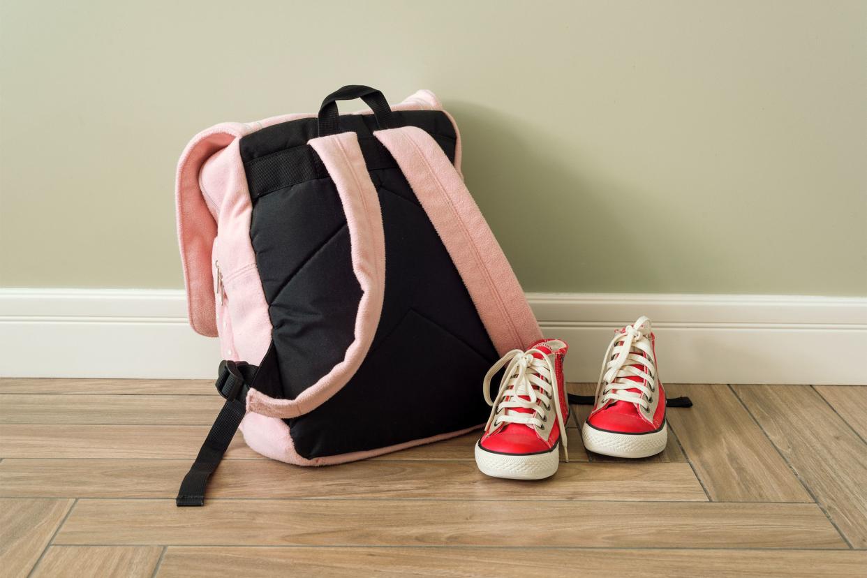 Backpack and sneakers on the floor