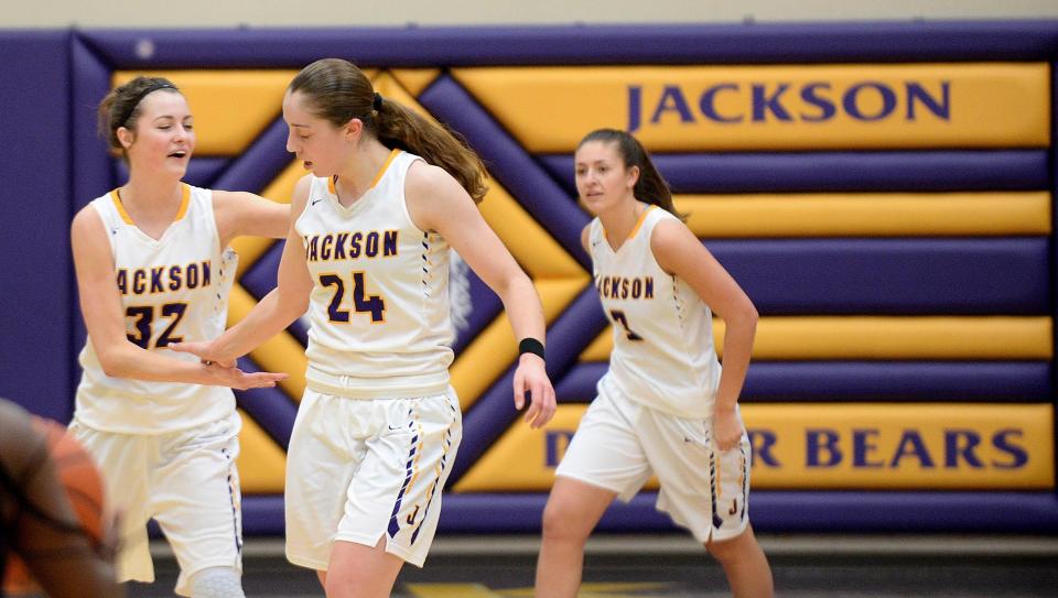 Jackson senior Taylor Mikesell enjoys her record-setting game with teammates, Feb. 10, 2018. Mikesell surpassed 2,000 career points in the first half, hit a school-record 14 3-point shots, became the Stark County all-time girls scoring leader when she passed 2,032 points on her way to a county-record 60-point game.