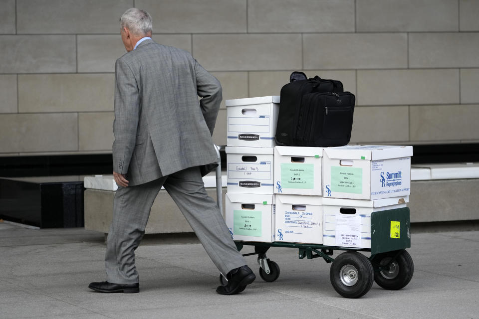 Case documents are wheeled into federal court Monday, June 17, 2024, in Los Angeles. NFL Commissioner Roger Goodell and Dallas Cowboys owner Jerry Jones, a longtime member of the league's broadcast committee, are expected to testify in a trial that could last up to three weeks. (AP Photo/Damian Dovarganes)