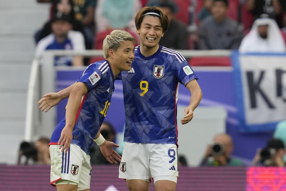 Japan's Ayase Ueda, right, celebrates with Japan's Ritsu Doan after scoring his side's third goal during the Asian Cup Round of 16 soccer match between Bahrain and Japan, at Al Thumama Stadium in Doha, Qatar, Wednesday, Jan. 31, 2024. (AP Photo/Thanassis Stavrakis)